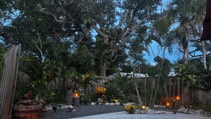 A pool surrounded by tropical plants and wooden fences. - Island Oasis on Manasota Key- Steps to both Gulf & Bay Access, Heated Pool (Englewood)