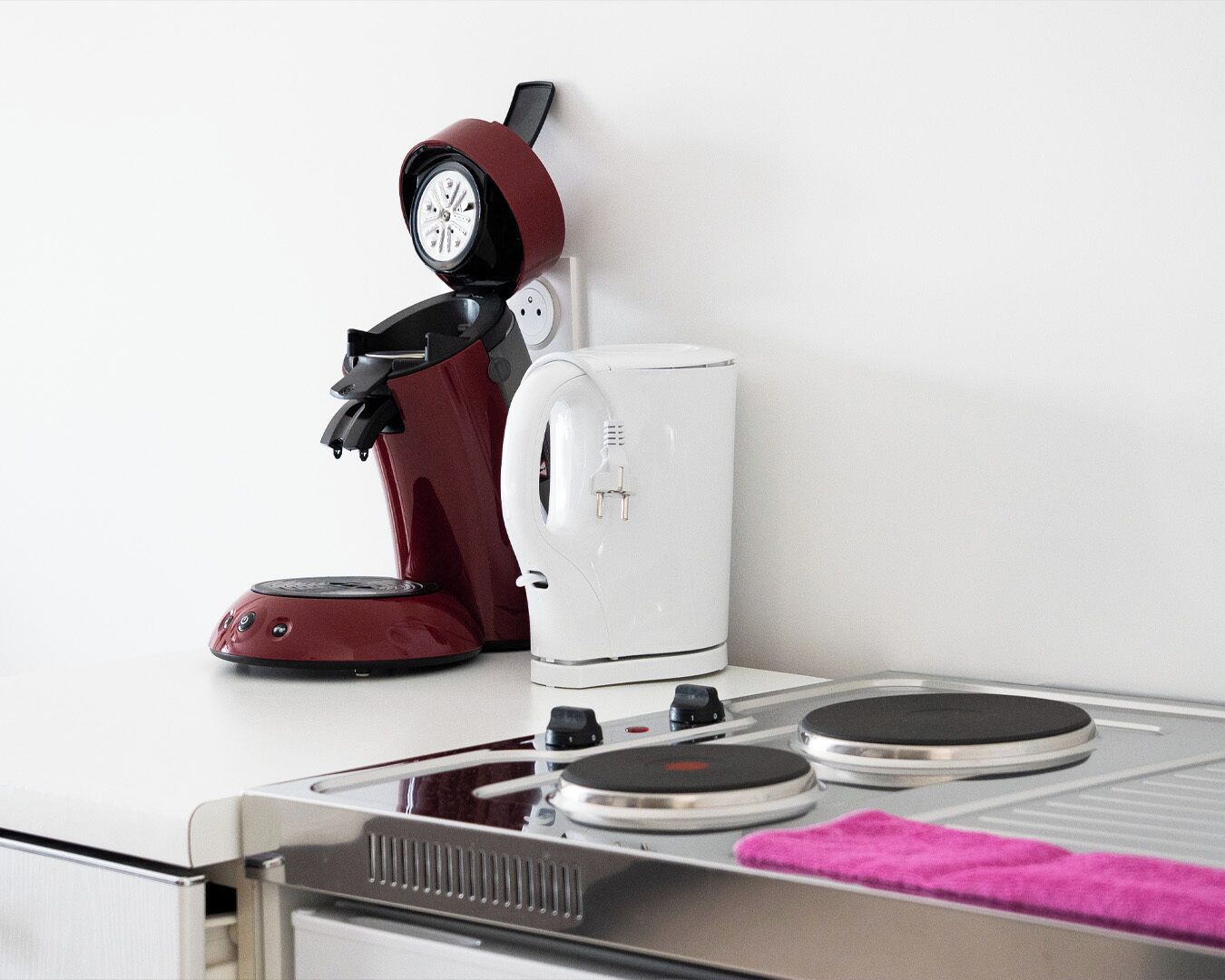 A coffee maker and a kettle on a kitchen counter.
