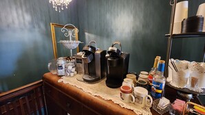 A coffee station with multiple coffee dispensers, a tea kettle, and various containers and mugs on a wooden counter. - Experience a 12-room historic home on Lake Manistique with your own private chef (Curtis)