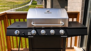 A Char-Broil gas grill with four burners and a stainless steel lid, placed on a wooden deck with a railing. - Luxury 5BD 4BR Sleep 12 - Large Groups, Family, Events , Wedding near Brantford (Brant)
