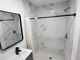 Shower, towels, soap, toilet paper