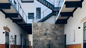 A modern building with a central courtyard, stone walls, and two potted plants. - Casona 212 |Luxury Loft in Puebla Centro + Parking (Heroica Puebla de Zaragoza)