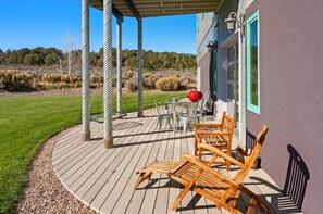 A wooden deck with outdoor furniture, a covered area, and a view of a natural landscape. - 25 Acre Artist Ranch, hot tub & tennis, near Aspen (Carbondale)
