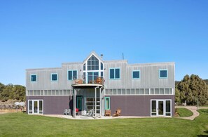 A modern two-story building with a flat roof, large windows, and a covered outdoor seating area. - 25 Acre Artist Ranch, hot tub & tennis, near Aspen (Carbondale)