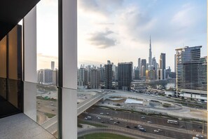 A high-rise building with a view of a cityscape, including a prominent skyscraper.