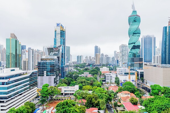 A cityscape with modern high-rise buildings, including a distinctive twisted skyscraper.