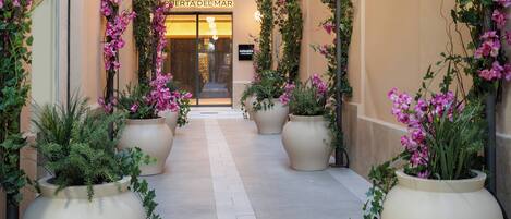 Entrada de un hotel con un letrero que dice 'HOTEL CATALONIA PUERTA DEL MAR'.