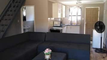 Departamento Confort, vista al patio | Área de sala de estar | Televisión de plasma de 32 pulgadas con canales vía satélite