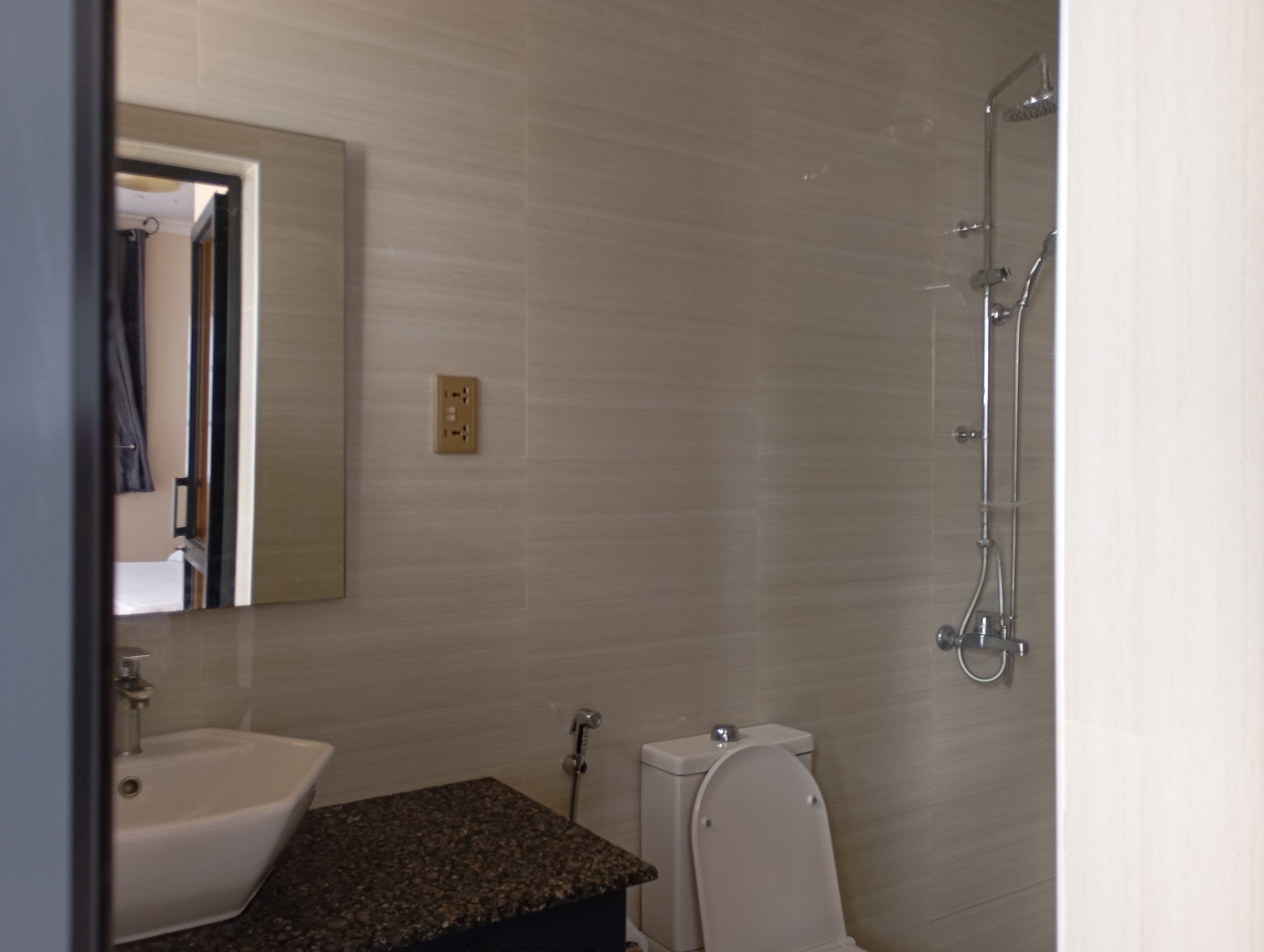 A bathroom with a sink, toilet, and shower.