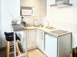 Fridge, microwave, coffee/tea maker, cookware/dishes/utensils