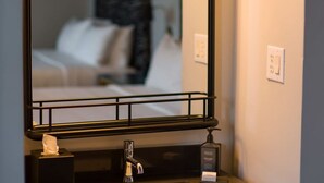 A bathroom with a mirror, a sink, and a hand soap dispenser. - Modern Unit with Pool Access, Near Union Square & Civic Center (San Francisco)
