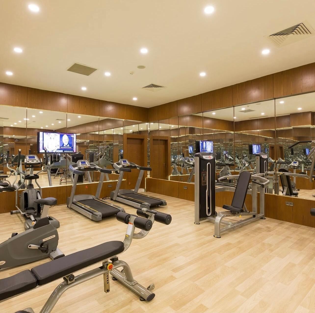 A gym with treadmills, weight machines, and exercise equipment.