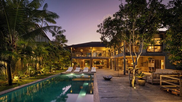 A two-story house with a pool, deck, and tropical vegetation. - Your luxury home in the heart of Trancoso (Trancoso)