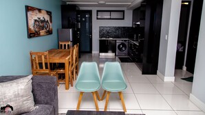 Una sala moderna con comedor, cocina y lavandería.