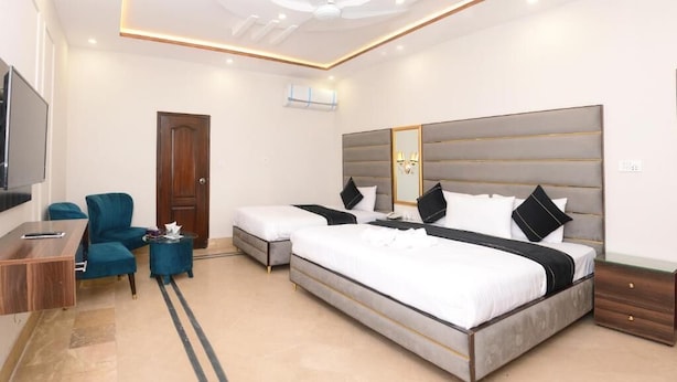 A modern hotel room with a large bed, a desk, a chair, and a television. - Five Seasons Hotel Lahore (Lahore)