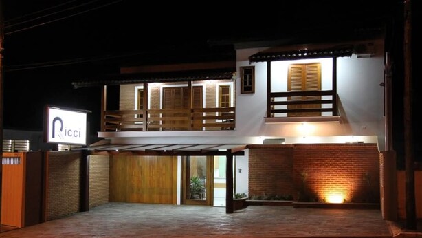 A two-story building with a sign reading "Ricci" and a covered entrance. - Hotel Ricci  (Batatais)