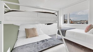 A bunk bed room with a window view of a parking lot. - Modern Gem, Spacious, Parking | THH (Ajax)