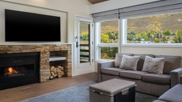 A living room with a fireplace, a sofa, and a television.