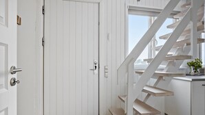 A white interior with a wooden staircase leading to an upper level. - Amazing home in Otterup with WiFi (Otterup)