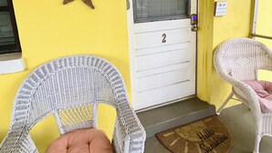A yellow exterior wall with decorative shells and a door marked with the number 2.