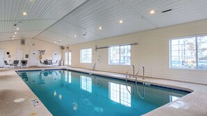 An indoor swimming pool with clear water, a tiled floor, and a ceiling with recessed lighting. - Stay Coastal-King Bed, Pools, Hot Tub, Tennis (Myrtle Beach)
