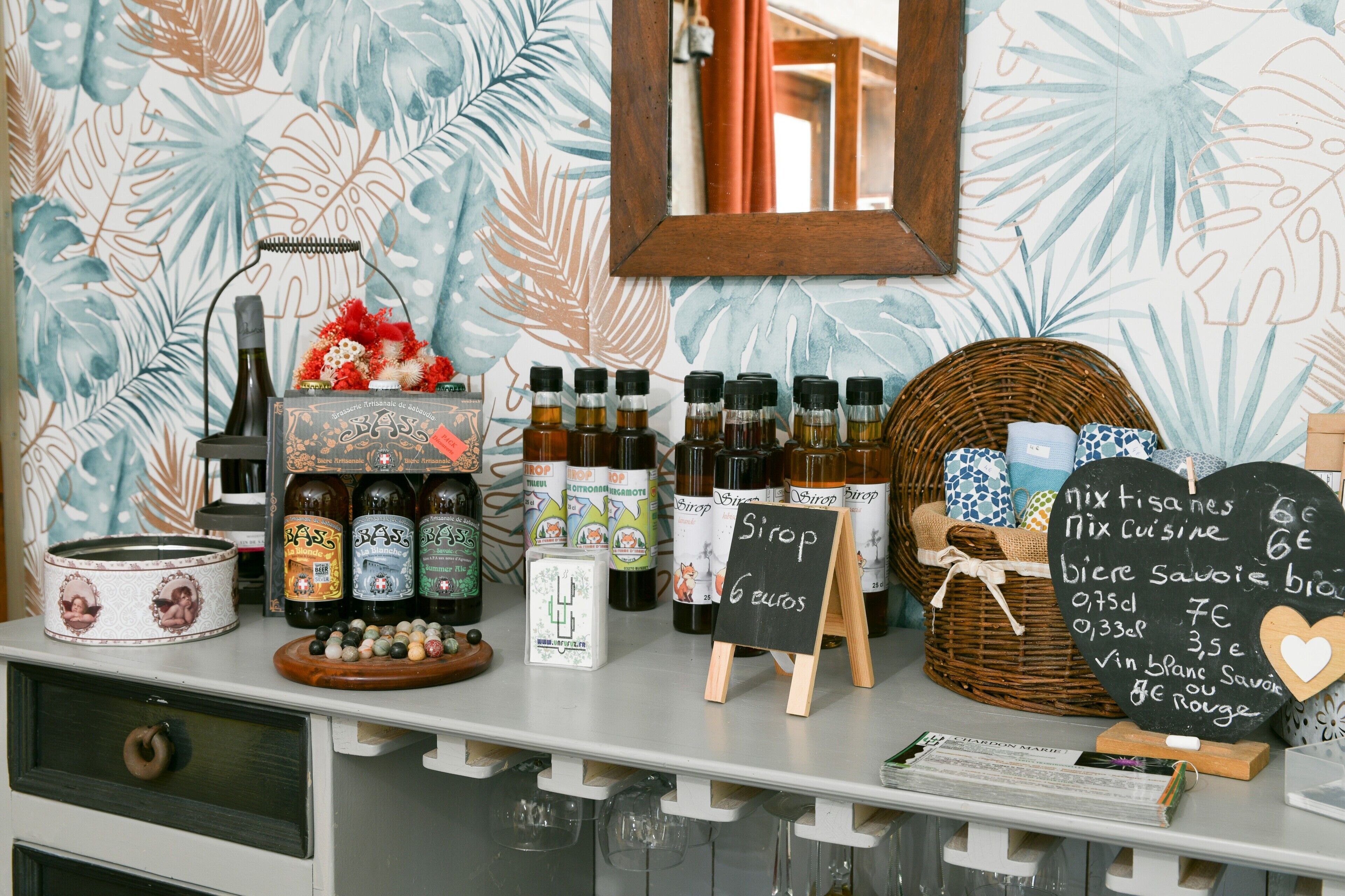 A bar area with bottles, a chalkboard menu, and a wicker basket.