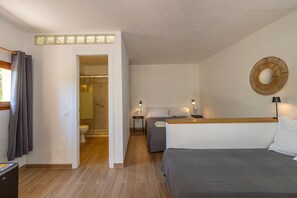 Een hotelkamer met een bed, nachtkastjes, een spiegel en een douche.
