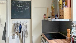 A compact kitchen with a blackboard, wooden countertop, and a sink. - Beautiful home in Dannemare with WiFi (Dannemare)