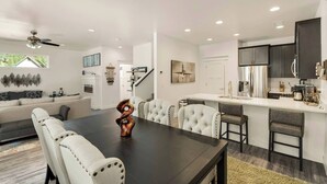 A modern kitchen with dark cabinets, a white countertop, and a built-in oven. - Outdoor Entertainment, Hot Tub, Modern, Quiet (Flagstaff)