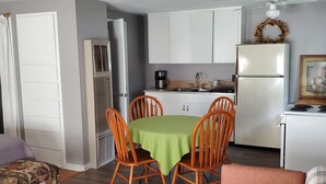 A compact living space with a dining area, kitchenette, and a small seating area. - Charming 1-bedroom apt Buffalo WY, on creek, AC,  WiFi, & 1 block from downtown. (Buffalo)
