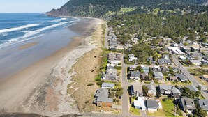 A coastal residential area with houses along the beach and a hilly backdrop. - The Spinn (Manzanita)