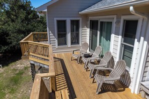 A deck with outdoor furniture and a wooden railing. - Joint Venture: Private Pool, Short Walk to Beach and Currituck Lighthouse (Corolla)