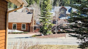 A residential area with a wooden house, a paved driveway, and a fenced yard. - Settlers Creek 6521 (Keystone)