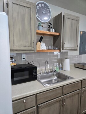 Fridge, microwave, stovetop, coffee/tea maker