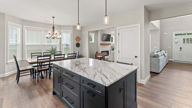 A spacious kitchen with a large island, black cabinetry, and pendant lighting. - Stylish 4BR w/ Huge Yard in Greer (Greer)