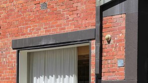 A brick building with a large window displaying the name "Aesop". - Indulgent stay in trendy Prahran (Prahran)