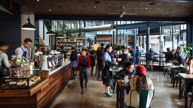 A busy cafe with a wooden counter, seating area, and large windows. - Indulgent stay in trendy Prahran (Prahran)