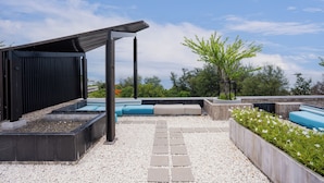 A rooftop patio with seating areas, a pergola, and a view of the landscape. - Beachside Chic Coastal Hideaway (Hua Hin)