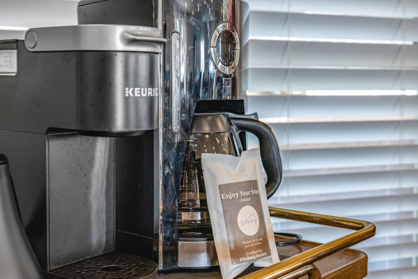A Keurig coffee maker with a branded coffee bag on a tray.