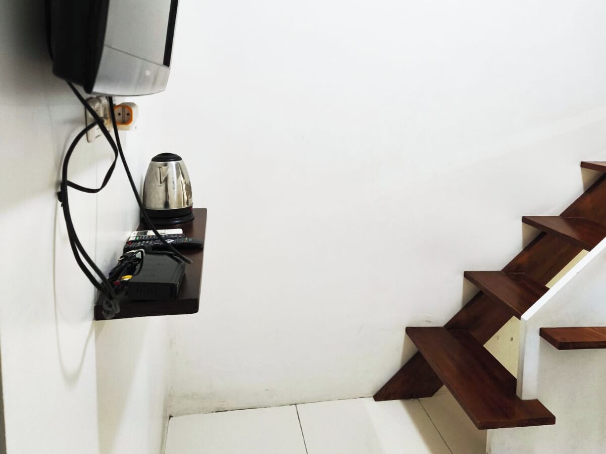 A staircase with wooden steps and a white wall.