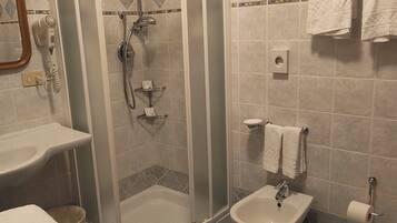 Shower, hair dryer, towels, toilet paper