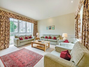 A living room with two sofas, a coffee table, and a red rug. - Doxford House - UK49888 (Doxford, near Embleton)