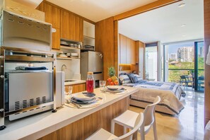 Una cocina moderna con electrodomésticos de acero inoxidable, armarios de madera y una barra desayunadora.