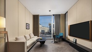 Ein modernes Wohnzimmer mit Sofa, Couchtisch und Fernseher.