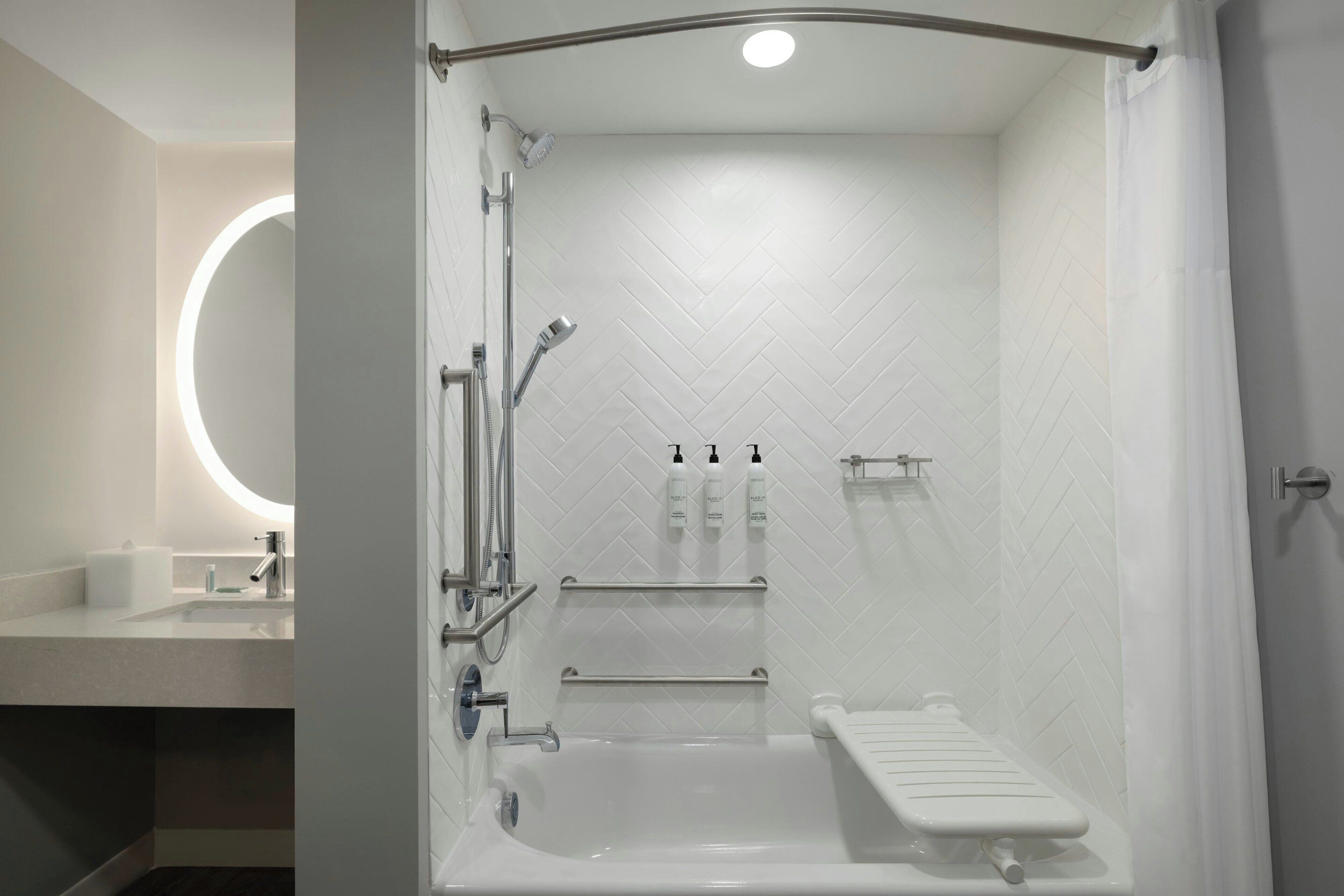 A modern bathroom with a walk-in shower, a bathtub, and a toilet.