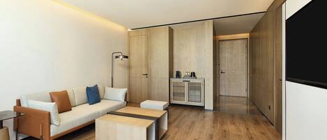 A modern living room with a sofa, coffee table, and a cabinet.