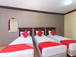 A hotel room with three single beds, each with a white mattress and red bedding. - INB Resort Ayer Keroh Melaka (Malacca City)