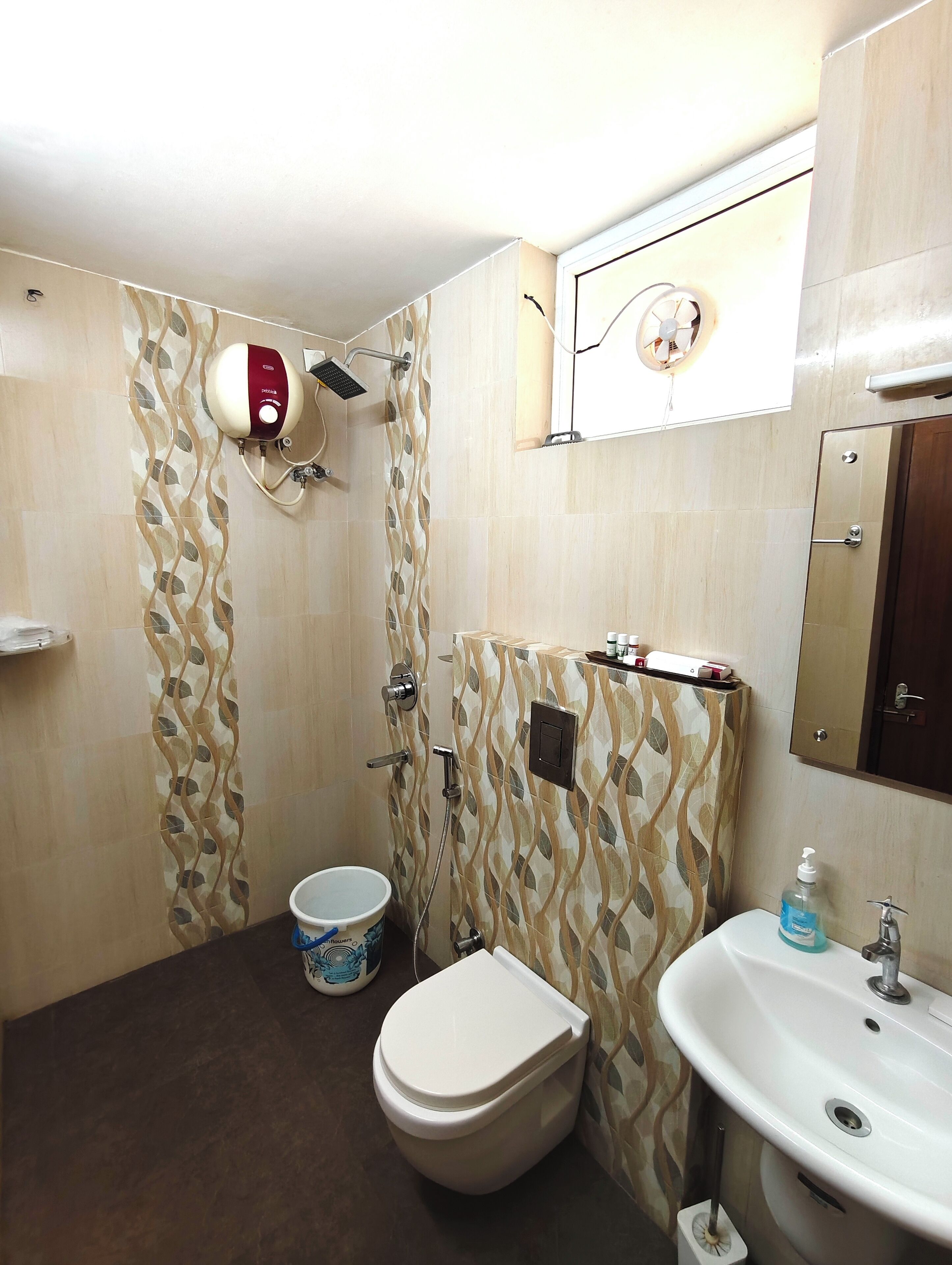 A bathroom with a toilet, sink, and shower.