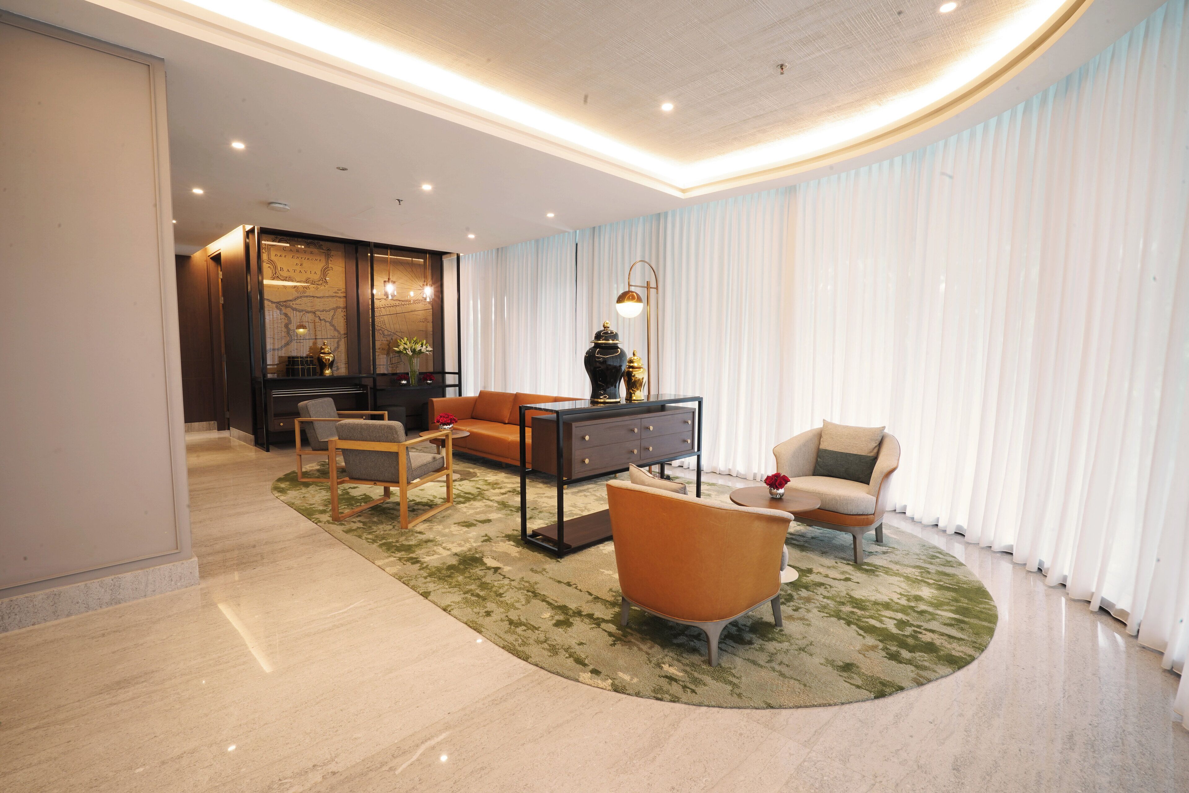 A modern living room with a sofa, armchairs, a coffee table, and a decorative vase.