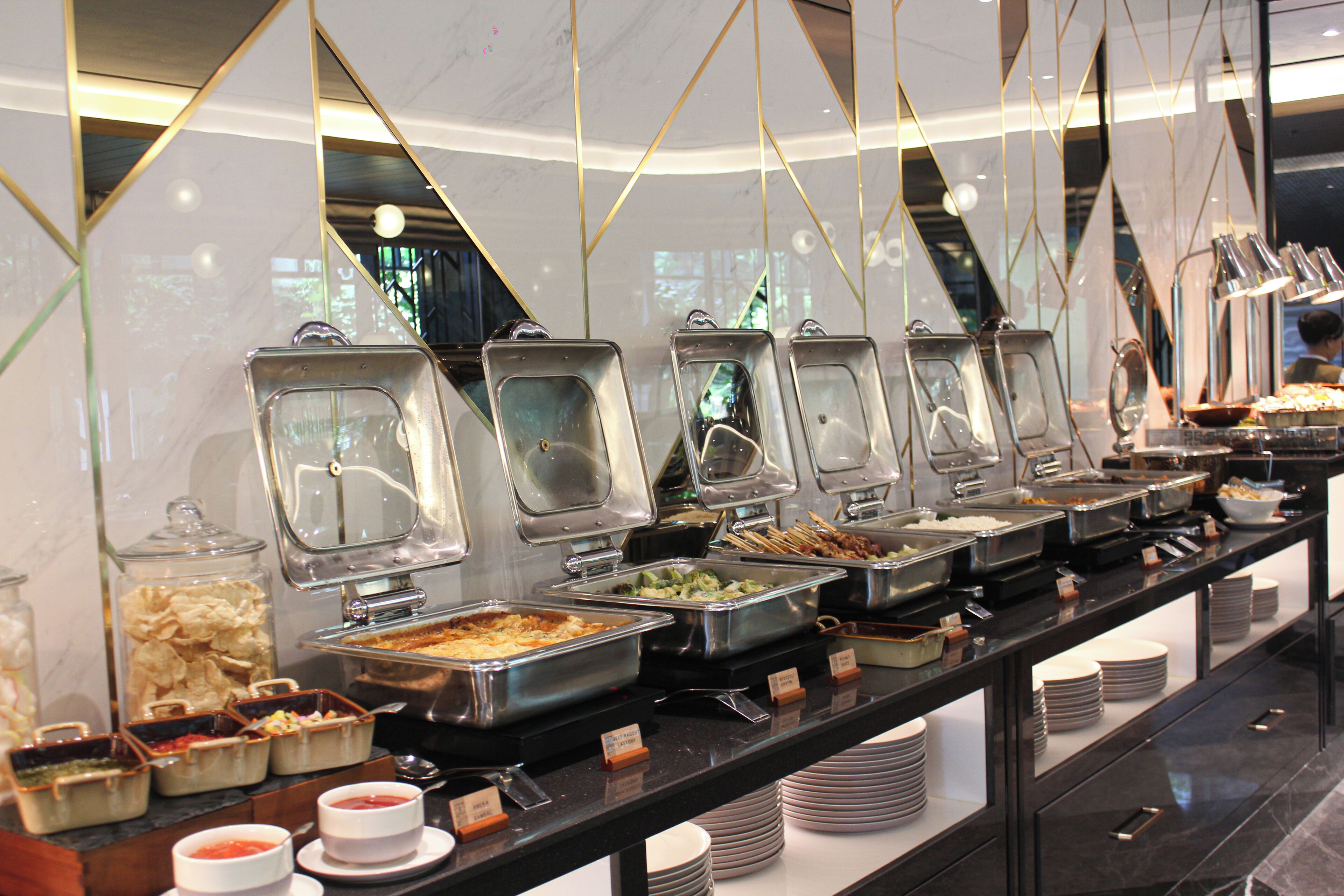A buffet with various food items and containers.